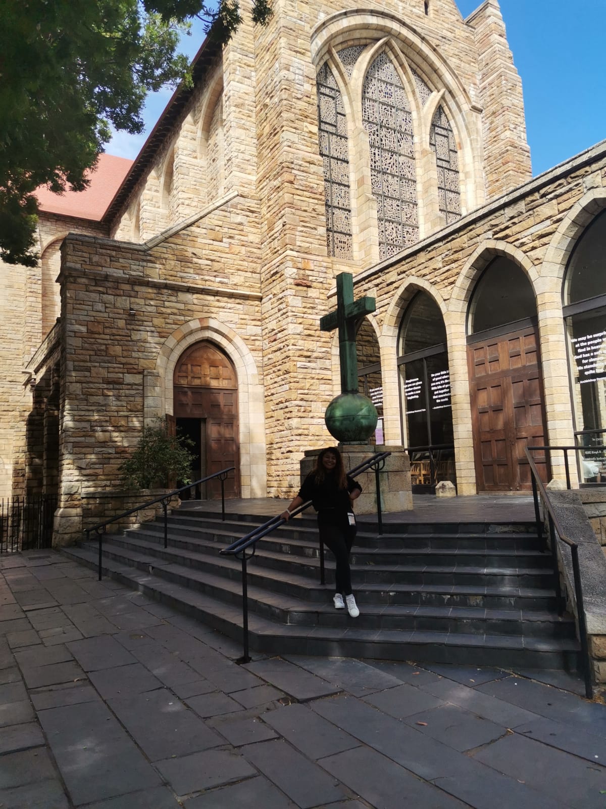 female standing in front of cathedral